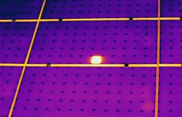 Infrared camera image of a solar panel showing defects as warmer areas